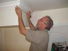 Carpenter Installing Crown Molding